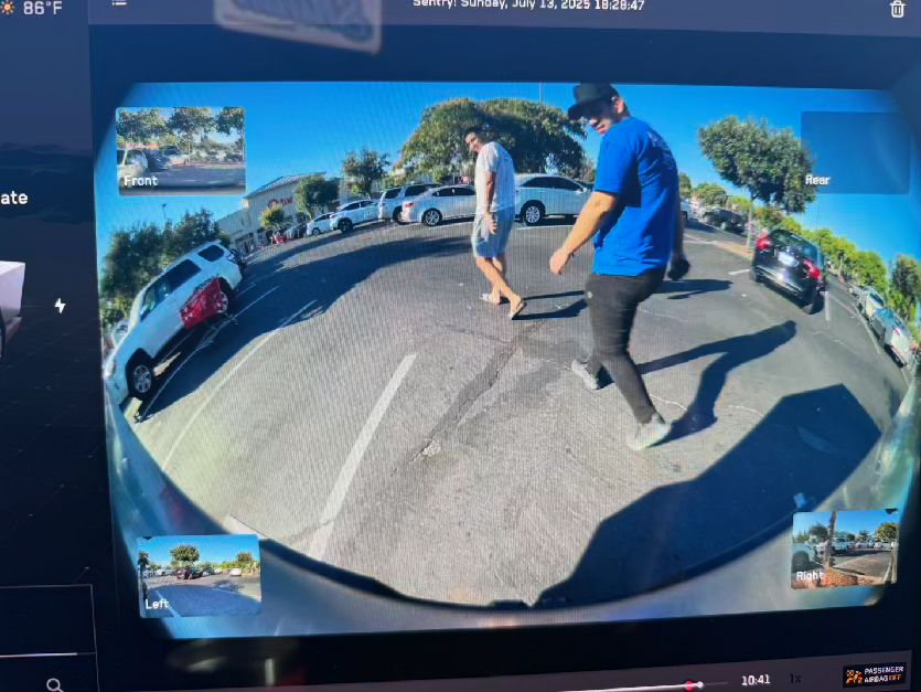 Tesla Sentry Mode capture — person reacting to Big Nutz in an indoor parking garage